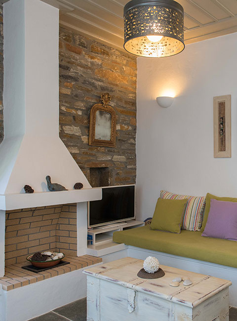 The sitting area and the fireplace of Rose home in Sifnos