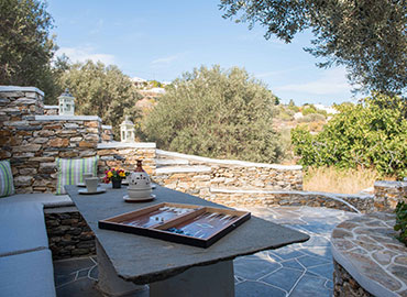 Stone table in the garden of Rose Home in Sifnos